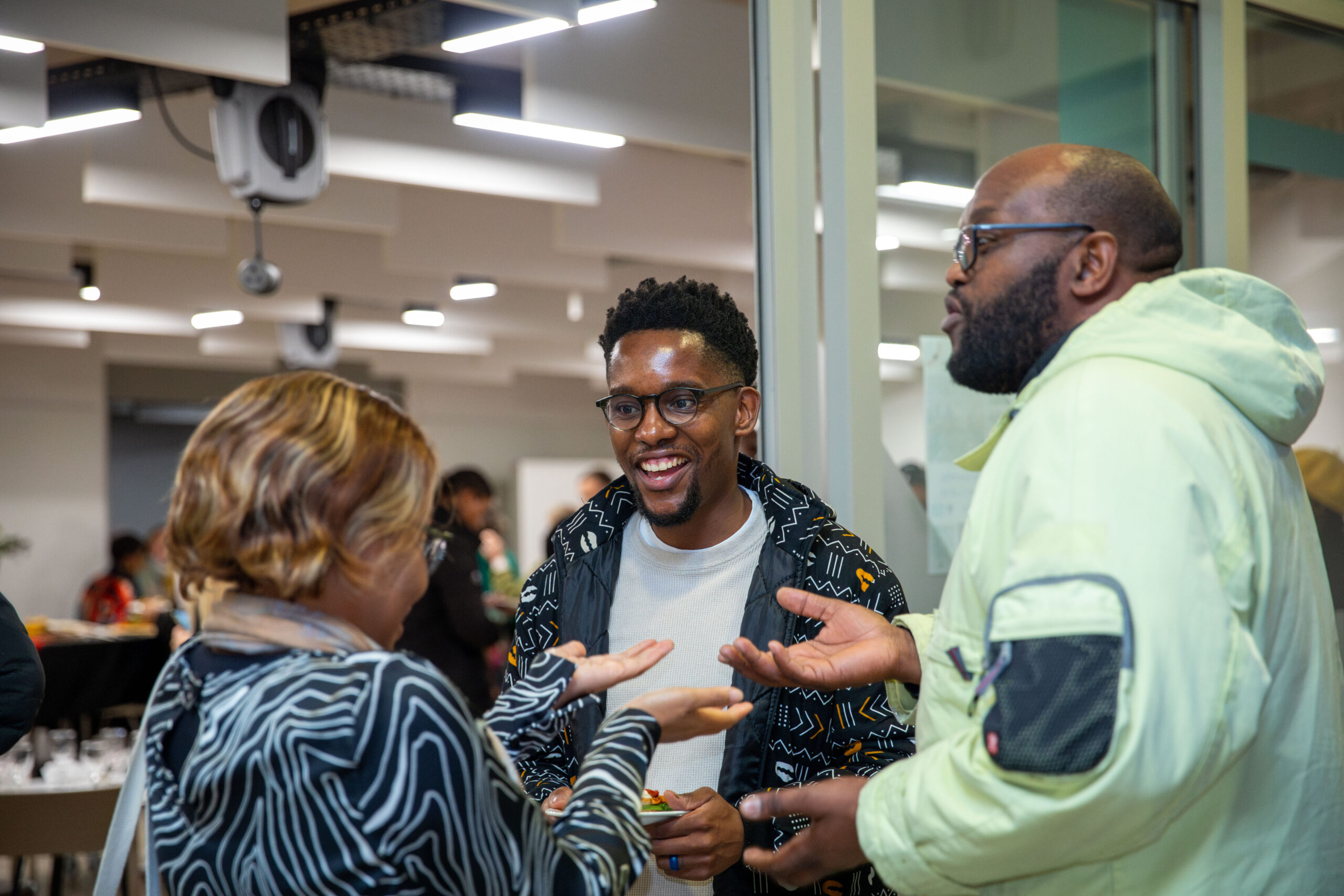 Two men and a woman deep in conversation at a d-school Afrika workshop.